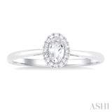 5x3 MM Oval Shape White Topaz and 1/20 Ctw Single Cut Diamond Halo Semi-Precious Ring in 10K White Gold